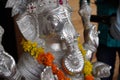 Lord Ganesha, Close up of Sculpture , Silver figure decorated with flowers, Indian Elephants. Large Silver metal statue of God