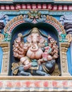 Lord Ganesha with Devi Riddhi on his knee.