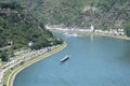 Urbar, Germany - 07 22 2020: cargo vessel, passenger ship and small boat in the Loreley passe with a view to Burg KAtz