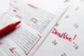 Lorem ipsum.Closeup of script, red marker and calendar with word Deadline on it