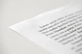 Lorem Ipsum dolor text on printed on paper in black and white, sample of document, side view, selective focus