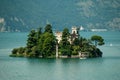Loreto island in the middle of the Iseo lake with green hills in the background