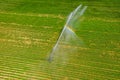 Loriol sur Drome, France - August 2022: Aerial view by a drone of a field being irrigated by powerful irrigation system.