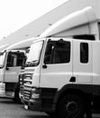 lorries parked up outside a company\'s car parking area no people stock photo