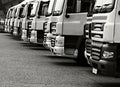 lorries parked up outside a company\'s car parking area no people stock photo