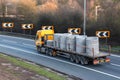 Lorry carrying builidng materials in motion on the British motorway M1