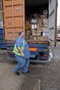 The lorry drive closes the doors of the container that is taking donated books