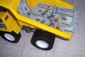 the lorry the dump truck with money in a body dollars yellow color a wheel black