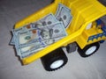 the lorry the dump truck with money in a body dollars yellow color a wheel black Royalty Free Stock Photo