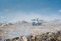 Lorry at the garbage dump full of smoke, litter, plastic bottles,rubbish and trash at tropical island Royalty Free Stock Photo