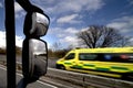 Lorry side mirror view, with blurred ambulance Royalty Free Stock Photo