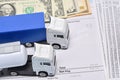 A lorry toys, payroll with dollar bill and face mask Royalty Free Stock Photo