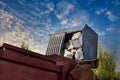 Lorry truck loading a skip waste management container