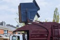 Lorry truck loading a skip waste management container