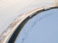 Lorry truck on the road surrounded by winter forest. Aerial view