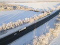 Lorry Truck On The Road Surrounded By Winter Forest. Aerial View