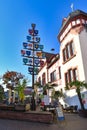 Lorsch, Germany - Traditional guild pole and part of old historic city hall building in front of blue sky