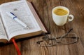 Personal Holy Bible study with a cup of coffee on a table top with eyeglasses Royalty Free Stock Photo