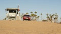 LOS ANGELES CA USA - 16 NOV 2019: California summertime Venice beach aesthetic. Iconic retro wooden lifeguard watchtower, baywatch Royalty Free Stock Photo