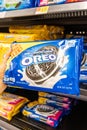 Shoppers hand holding a package of Nabisco`s Oreo brand milk chocolate cookies