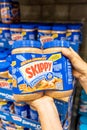 Shoppers hand holding a Twin Pack Plastic Jars of Skippy brand peanut butter Royalty Free Stock Photo