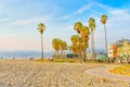 Los Angeles, California - December 29, 2022: Venice Beach - Shoreline, Buildings, Tall Palm Trees and Clear Blue Sky