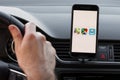 LOS ANGELES, CALIFORNIA - JUNE 6, 2019: Close up to male driving and using different navigation application Google maps, Apple