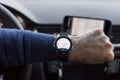 LOS ANGELES, CALIFORNIA - JUNE 6, 2019: Close up to male driving and using navigation application HERE WeGo on the smart watch