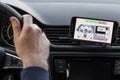 LOS ANGELES, CALIFORNIA - JUNE 6, 2019: Close up to male driving and using navigation appliction Google Android Auto. An
