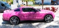 Los Angeles, California USA - April 14, 2021: pink ford mustang GT luxury car parked side view.