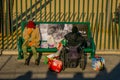 Los Angeles, California, USA, AUGUST, 20, 2018: Outdoor view of homeless couple on a park bench, woman in a wheel chair