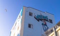 Street art on Venice Beach, Los Angeles. Colorful building with graffiti on blue sky background