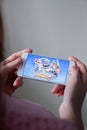 Los Angeles, California, USA - 8 March 2019: Hands holding a smartphone with Clash Royale game on display screen Royalty Free Stock Photo