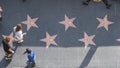 LOS ANGELES, CALIFORNIA, USA - 7 NOV 2019: Walk of fame promenade on Hollywood boulevard in LA. Pedastrians walking near celebrity Royalty Free Stock Photo