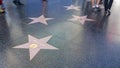 LOS ANGELES, CALIFORNIA, USA - 7 NOV 2019: Walk of fame promenade on Hollywood boulevard in LA. Pedastrians walking near celebrity Royalty Free Stock Photo