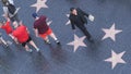 LOS ANGELES, CALIFORNIA, USA - 7 NOV 2019: Walk of fame promenade on Hollywood boulevard in LA. Pedastrians walking near celebrity Royalty Free Stock Photo