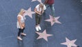 LOS ANGELES, CALIFORNIA, USA - 7 NOV 2019: Walk of fame promenade on Hollywood boulevard in LA. Pedastrians walking near celebrity Royalty Free Stock Photo