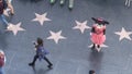 LOS ANGELES, CALIFORNIA, USA - 7 NOV 2019: Walk of fame promenade on Hollywood boulevard in LA. Pedastrians walking near celebrity Royalty Free Stock Photo