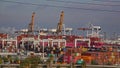 Ships, equipment and shipping containers crowd a Port of Los Angeles container freight operation.