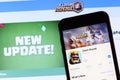 Los Angeles, California, USA - 28 November 2019: Clash Royale app icon on mobile phone screen with logo on laptop on blurry