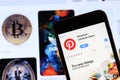 Los Angeles, California, USA - 28 November 2019: Pinterest app icon on mobile phone screen with logo on laptop on blurry