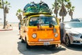 Los Angeles, California, USA - 2019 orange mini bus surfers on Venice Beach