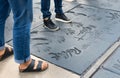 Two girls visitor standing in the footprints of Hollywood legends from the movie Twilight at Graumans Chinese Theater