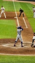 Los Angeles Dodgers baseball player Mookie Betts standing at home plate holding a bat surrounded by an umpire other players