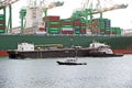 San Pedro/California - April 4, 2020: Los Angeles Harbor Shipyard cranes at work unloading cargo ship containers. Royalty Free Stock Photo