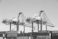 San Pedro/California - April 4, 2020: Los Angeles Harbor Shipyard cranes at work unloading cargo ship containers. Royalty Free Stock Photo