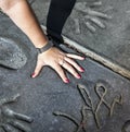 Fan puts hand in handprints of twilight saga stars