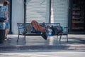 LOS ANGELES, USA - AUGUST 1, 2014 - Homeless sleeping on a bench on Walk of Fame