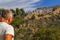 LOS ANGELES, USA - July 5, 2018, a tourist looking thoughtfully at the Hollywood sign on the Hollywood hills in California, the