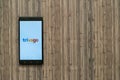 Trivago logo on smartphone screen on wooden background.